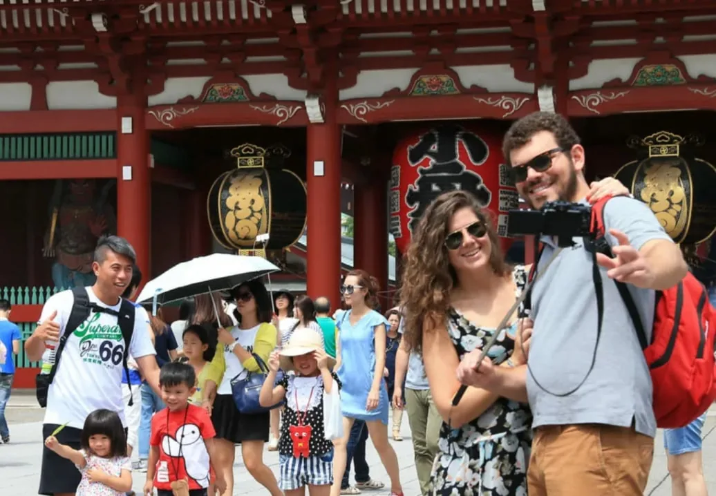 浅草寺の門前で記念写真を撮る旅行者たち